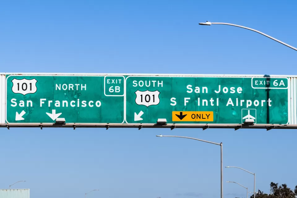 A highway sign reads with directions to reach San Francisco to the north and San Jose to the south--both on Highway 101.